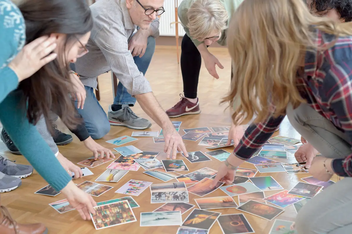 Group of people choosing picture cards for a coaching exercise