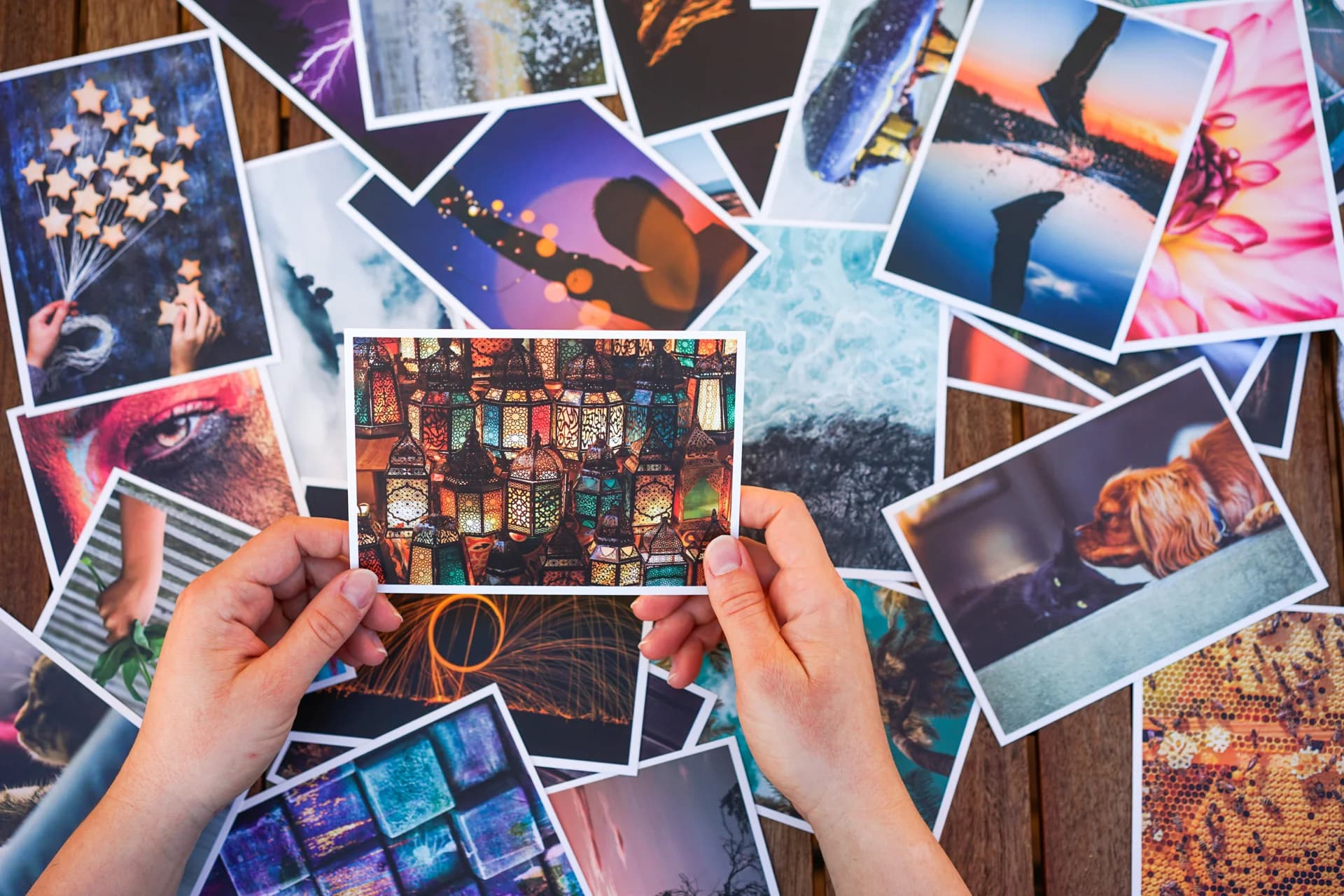 Hands holding a picture card with many cards spread out